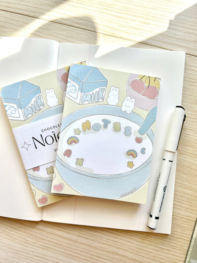Chocolett - Cereal Memo-Pad

This memopad comes with 50 thick pages and measures 5.5 x 4 inches big. It’s cutely decorated with a little breakfast cereal scene and tiny bunnies.

Please note that these are not sticky notes.