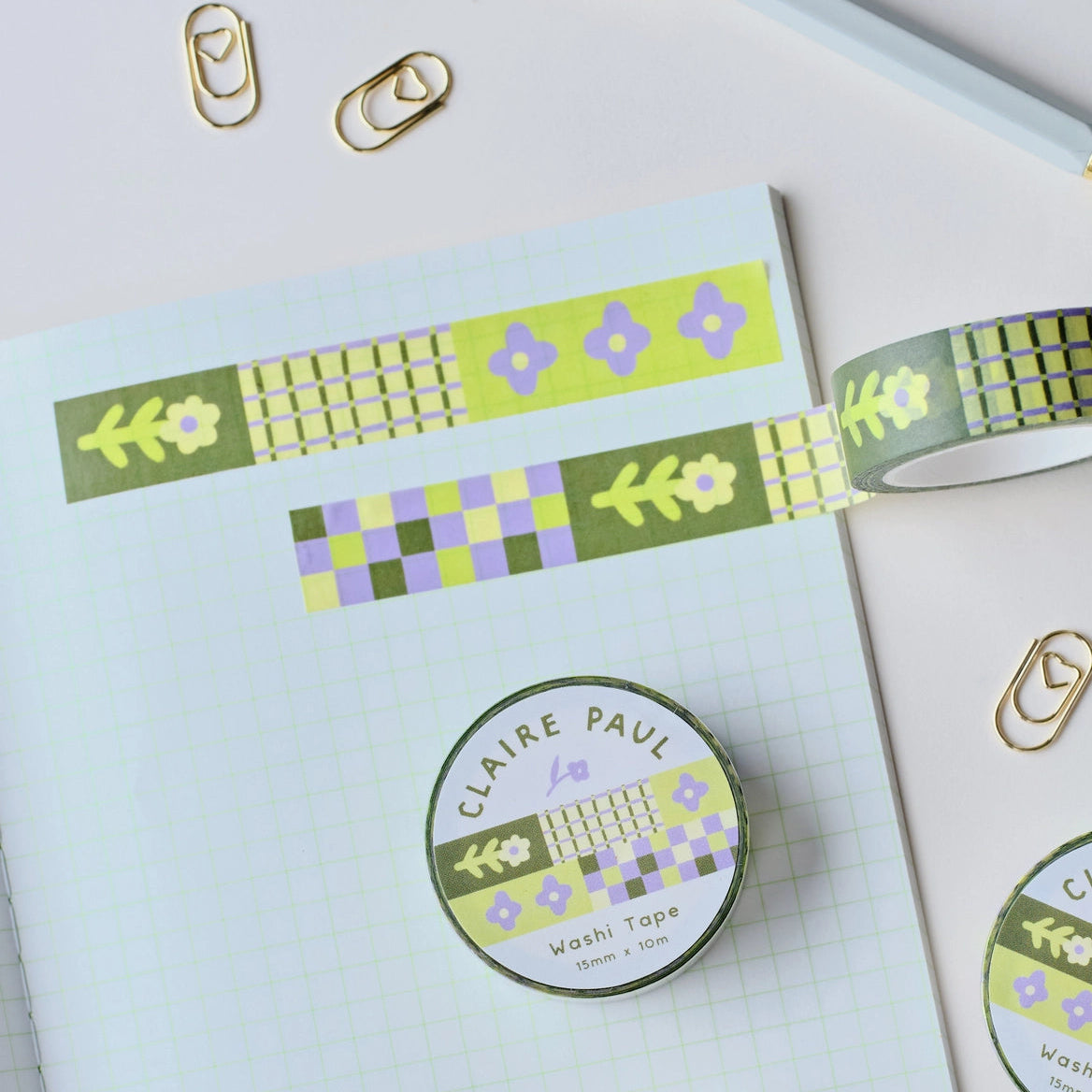 Flower Patch pattern washi tape! This tape featured illustrated florals, checkerboard and a grid pattern in a green, purple and cream colour palette.

This paper masking tape is perfect for decorating your bullet journal and planners, scrapbooking &amp; gift wrapping. It'll add some fun and colour to any surface and is easy to peel off.

10m x 15mm