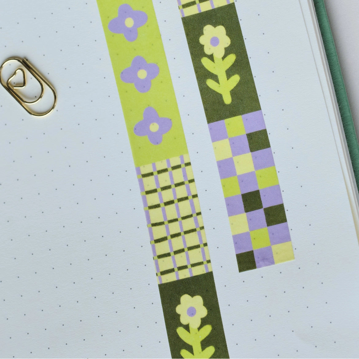 Flower Patch pattern washi tape! This tape featured illustrated florals, checkerboard and a grid pattern in a green, purple and cream colour palette.

This paper masking tape is perfect for decorating your bullet journal and planners, scrapbooking &amp; gift wrapping. It'll add some fun and colour to any surface and is easy to peel off.

10m x 15mm