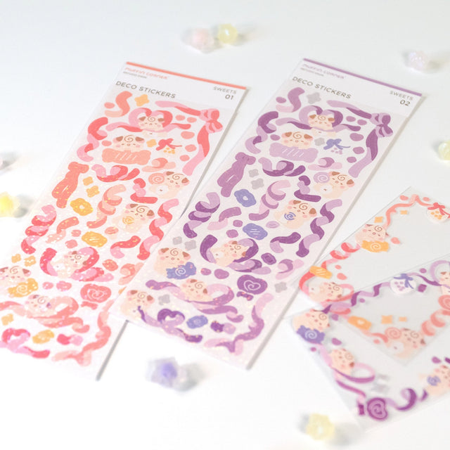 The Cocoroll Sweets deco sticker sheet features Cocoroll surrounded by adorable candies. Available in pink and purple versions, these cute deco stickers are the perfect addition to any polaroids/toploaders, journals, and more. The sparkly holo overlay adds an extra touch of shine and magic.

Dimensions: 2.7” x 8" (6.8cm x 20.5cm)
Quantity: 1 sheet