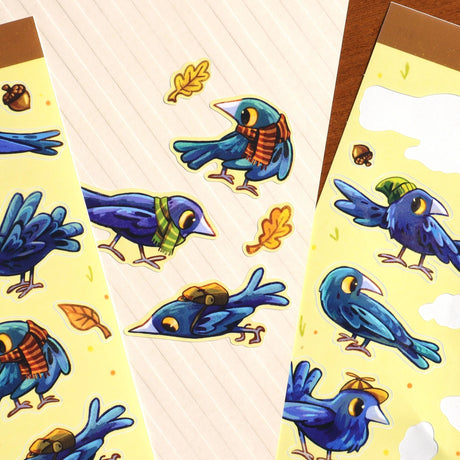 A bunch of crows with various accessories. Some backpacks, scarves and hats! 8 Total large stickers, and 6 smaller stickers.

Waterproof vinyl sticker sheet, 5"x7"
14 peelable stickers per sheet
Durable and high quality
Packaged in a clear plastic sleeve