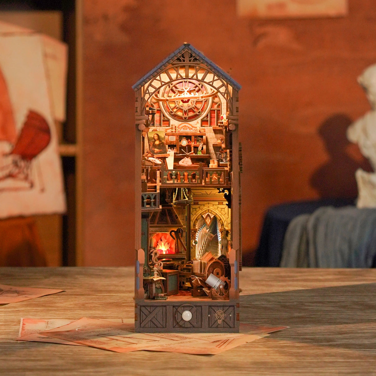 This miniature scene captures the soul of a Renaissance studio-arched windows filtering in warm light, a wooden easel displaying a half-finished sketch, parchment scrolls and notebooks scattered across a weathered worktable, and tools of invention and artistry tucked into every corner.&nbsp;

Illuminate your nook with a gentle tap on the touch-sensor power button. Or use the feature SMART SENSOR with a range of 20 inches, the LED light will seamlessly illuminate upon detection and gracefully fade out after 