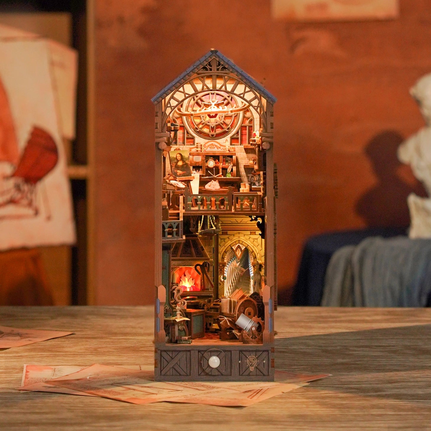 This miniature scene captures the soul of a Renaissance studio-arched windows filtering in warm light, a wooden easel displaying a half-finished sketch, parchment scrolls and notebooks scattered across a weathered worktable, and tools of invention and artistry tucked into every corner.&nbsp;

Illuminate your nook with a gentle tap on the touch-sensor power button. Or use the feature SMART SENSOR with a range of 20 inches, the LED light will seamlessly illuminate upon detection and gracefully fade out after 