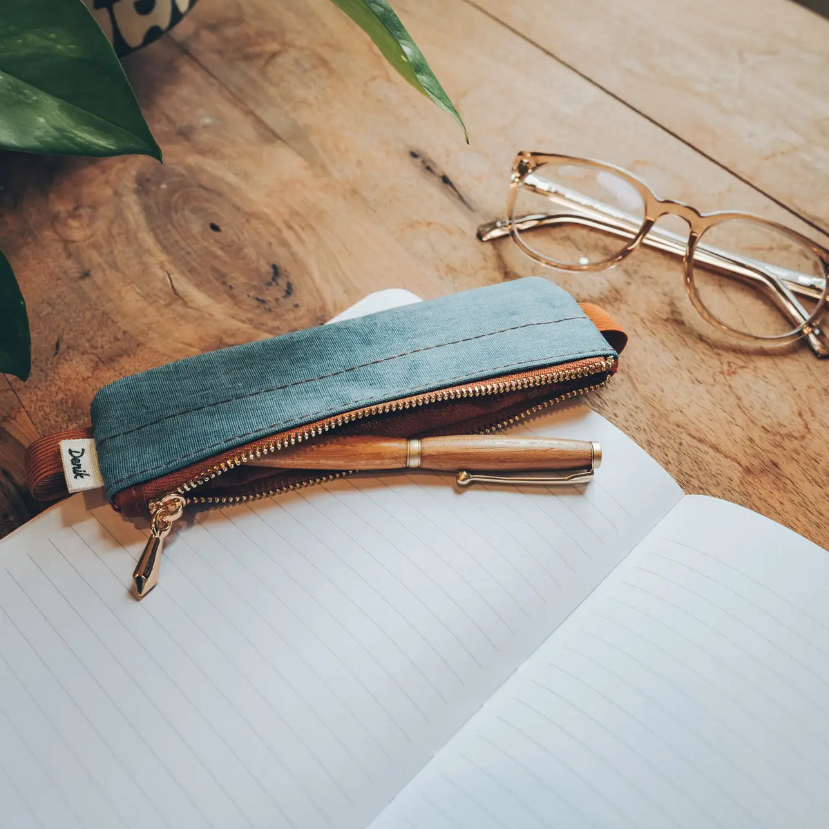 Denim Distressed Blue Notebook Pouch

Keep your go-to notebook and must-have pens together with our Denim Blue Notebook Pouch (honestly, we should’ve made these sooner). Designed with a fabric front, PU back, and a fully nylon-lined interior, it features an elastic band that fits snugly around most notebooks—so you’re ready for everyday ideas on the go.

Vegan Leather Pouch with Zipper
Elastic Fits Books up to 9" High
Zipper closure
9" x 3.75"