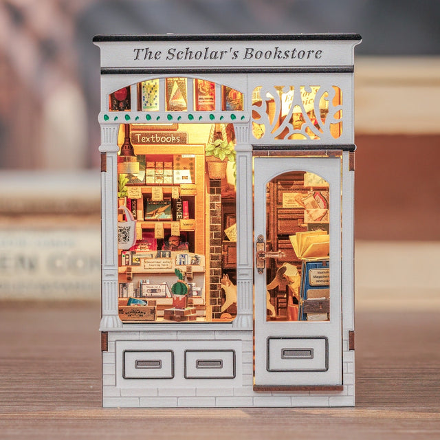 From the intricate woodwork of the storefront to the tiny posters, plants, and meticulously arranged reading materials inside, every piece invites you to slow down, take your time, and craft a scene that feels like a sanctuary for the soul. Whether you place it on your bookshelf or gift it to a fellow book lover, this book nook transforms any space into a story waiting to be told.