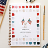 Twelve illustrations of flags, stars, and classic summer scenes — each pre-outlined with step-by-step instructions. Paintings take about thirty minutes from start to finish, making it approachable for first-time painters and a favorite for gifting.

A timely release for America's 250th anniversary in 2026. A strong May–July seller and a natural fit for home, gift, and patriotic-themed boutiques.

12 beginner-friendly illustrations
Thick 120lb watercolor paper&nbsp;
Lay-flat pages with spiral binding for has
