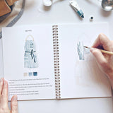 Emily Lex Studio Watercolor Workbook - Baking

Twelve baking illustrations — a cupcake, layer cake, mixing bowl, lattice pie, tray of cookies, rolling pin with cookie cutters, and more — each pre-outlined with step-by-step instructions. Paintings take about thirty minutes from start to finish, making it approachable for first-time painters and a favorite for gifting.

12 beginner-friendly illustrations
Thick 120lb watercolor paper&nbsp;
Lay-flat pages with spiral binding for hassle-free painting and easy te