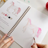 Twelve storybook illustrations — a princess, castle, dragon, mermaid, fairy, unicorn, and more — each pre-outlined with step-by-step instructions. Paintings take about thirty minutes from start to finish, making it a favorite for young painters and the grown-ups who paint alongside them.

12 beginner-friendly illustrations
Thick 120lb watercolor paper&nbsp;
Lay-flat pages with spiral binding for hassle-free painting and easy tear-out&nbsp;
Lightly outlined sketches to guide you&nbsp;
Easy to carry, travel-r