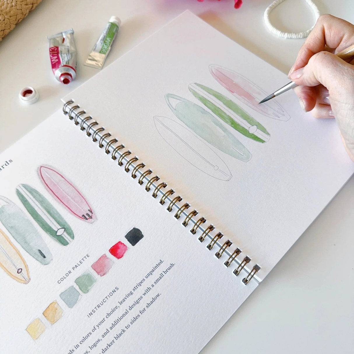 Emily Lex Studio Watercolor Workbook - Tropical

Twelve tropical illustrations — a palm tree, hibiscus, sea turtle, flamingo, pineapple, surfboards, and more — each pre-outlined with step-by-step instructions. Paintings take about thirty minutes from start to finish, making it approachable for first-time painters and a favorite for gifting.

12 beginner-friendly illustrations
Thick 120lb watercolor paper&nbsp;
Lay-flat pages with spiral binding for hassle-free painting and easy tear-out&nbsp;
Lightly outlin
