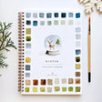 Twelve winter illustrations — a snowman, A-frame cabin, fair isle sweater, snow globe, ice skaters, mittens, and more — each pre-outlined with step-by-step instructions. Paintings take about thirty minutes from start to finish, making it approachable for first-time painters and a favorite for gifting.