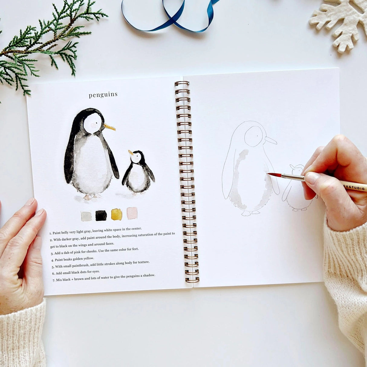 Twelve winter illustrations — a snowman, A-frame cabin, fair isle sweater, snow globe, ice skaters, mittens, and more — each pre-outlined with step-by-step instructions. Paintings take about thirty minutes from start to finish, making it approachable for first-time painters and a favorite for gifting.