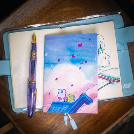 Esterbrook x Sakuradragon - Sakura Street Morning Skies A6 Notebook

Mornings are quiet around here.

Did you notice the pink foil cherry blossoms falling from the sky?

Dimensions: &nbsp;A6 (10.5 × 14.8 cm)
Paper: Double-sided offset paper
Page Ruling: Blank
Pages: 64


Message from sakuradragon: &nbsp;Not all paper and ink are made equal but this paper does a great job with both fountain pens and dip pens. There is minimal ghosting but bleeding does occur with heavy ink usage.