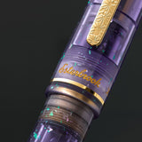 Esterbrook x Sakuradragon Sakura Street Estie Fountain Pen

Created with artist Cindy Duong of Sakuradragon, the Sakura Street Estie brings her imaginative illustrated world to Esterbrook's traditional Estie fountain pen. Its U.S.-blended material combines translucent purple with colorful glitter sparkle, while the custom clip is etched with Cindy's Sakura pattern. Dual Esterbrook and Sakuradragon engraving and a gold-plated converter finish the design. Each pen arrives in special packaging with Japanese gi