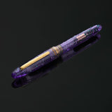 Esterbrook x Sakuradragon Sakura Street Estie Fountain Pen

Created with artist Cindy Duong of Sakuradragon, the Sakura Street Estie brings her imaginative illustrated world to Esterbrook's traditional Estie fountain pen. Its U.S.-blended material combines translucent purple with colorful glitter sparkle, while the custom clip is etched with Cindy's Sakura pattern. Dual Esterbrook and Sakuradragon engraving and a gold-plated converter finish the design. Each pen arrives in special packaging with Japanese gi