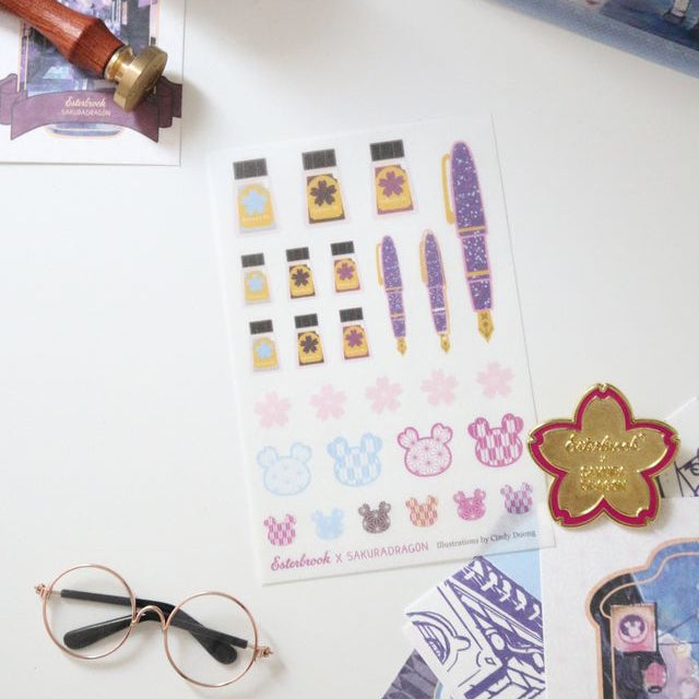 Add the whimsy of Sakura Street to journals, planners, and letters with this premium matte washi sticker sheet. Cindy Duong's original designs include the Sakura Street Estie, coordinating ink bottles, sakura blossoms, and the artist's Sakura Dragon, along with decorative elements drawn from the wider collection.
