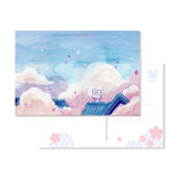 Send a note from Sakura Street with this set of three premium postcards featuring Cindy Duong's original illustrations. The set includes the Dino Sky, Dino Sakura, and Sakura Street designs, each printed on heavyweight cardstock. A custom address layout on the reverse adds more of the collection's playful artwork to every piece of correspondence.