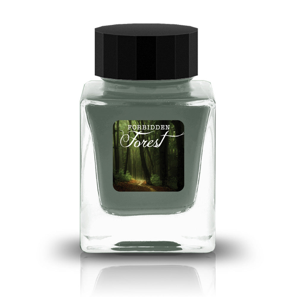 Forbidden Forest is a soft, misty green with blue-grey undertones and warm golden-brown shading. The color evokes morning fog drifting through ancient woodlands, where sunlight filters through moss-covered branches. In heavier applications, the ink deepens into rich teal-grey pools, while lighter strokes reveal a delicate, ethereal sage green. The contrast between cool forest tones and warm amber edges creates a beautifully organic, weathered appearance.