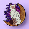 Calling all owners of a long haired pointed / meezer cats! This super cute design features the cat sitting in front of a sparkly moon with a glittery, starry sky in the background.

The pin is 40mm (1.57”) tall, and is made from gunmetal hard enamel, with glitter and UV printed details. It's secured with 2 pink clutches to keep the pin in place.