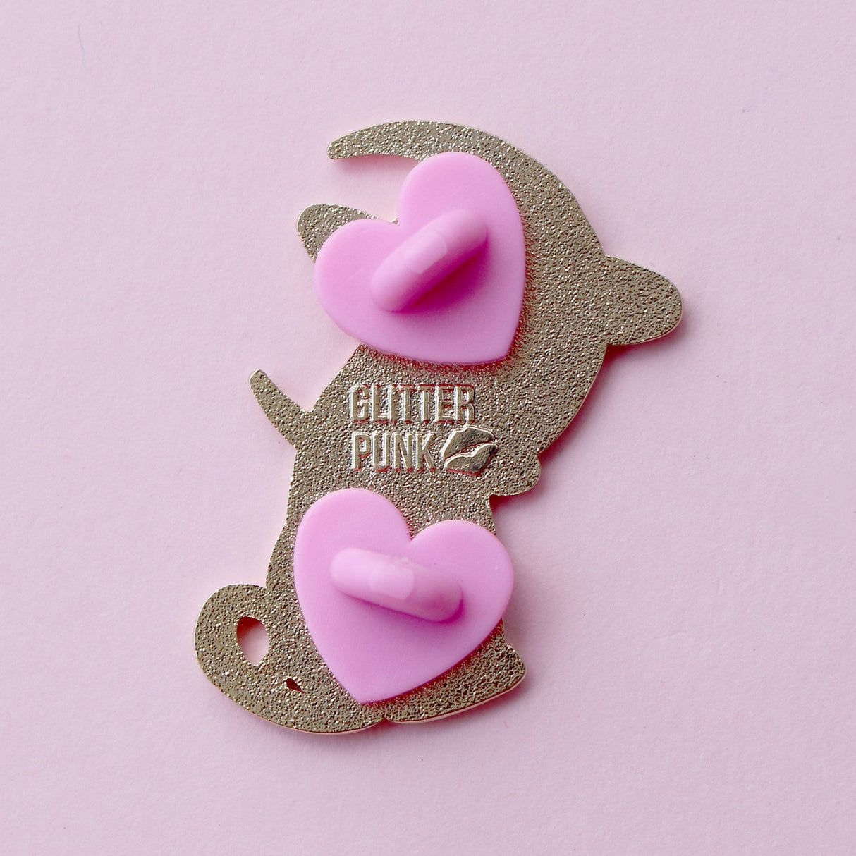 Cute, cuddly and clever – there’s no cat quite like a Sphynx! This fab enamel pin features a black Sphynx covered in mystical symbols, sitting in front of a crescent moon with 2 purple clouds.

The pin is 42mm (1.65”) tall, and is made from gunmetal hard enamel, with glitter and UV printed details. It's secured with 2 pink clutches to keep the pin in place.