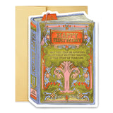 A bookish birthday card for lovers of stories and symbolism. This periwinkle card features a lush, gold-foiled tree with an open book at its roots and the message “May this year be another beautifully written chapter in the story of your life.” A thoughtful and elegant foil-pressed stationery piece.

Product Details:
- Dimensions: 5" x 7"
- Die-cut antique book-style design
- Hand-illustrated with gold foil details
- Blank interior
- Offset and foil printed
- Comes with envelope