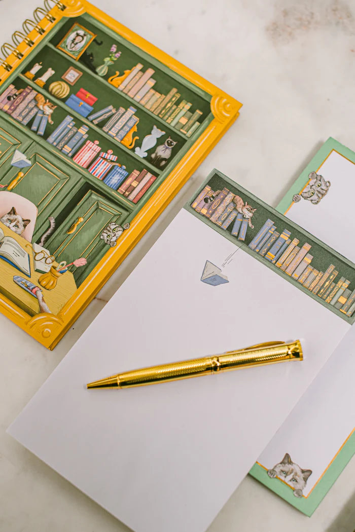 For cat lovers, book lovers, and anyone who believes planning should be delightful, the Cat Library Undated Weekly Planner brings a playful twist to everyday organization. The cover features a vintage-inspired library scene where curious cats lounge, climb, and quietly cause chaos among the shelves. Finished with gold foil details and gold wire binding, this planner feels whimsical yet polished.