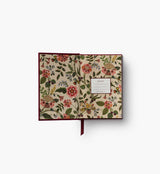 A mini hardcover journal, embroidered with delicate Gracie blooms and gold accents. Inside, find 240 blank, unlined pages and a ribbon bookmark.