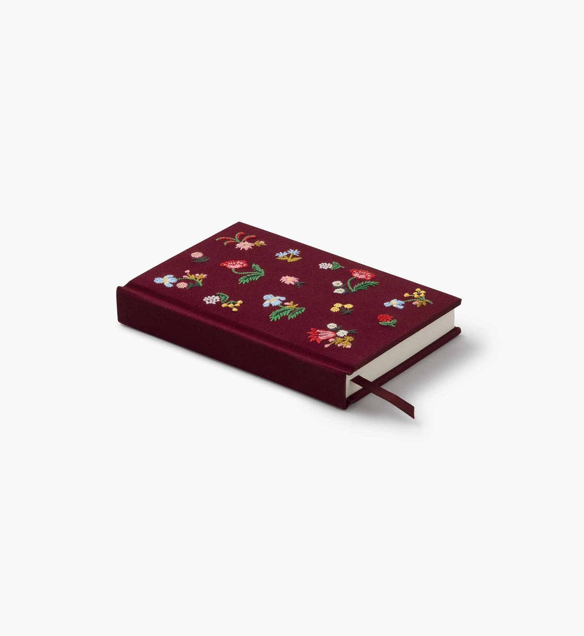 A mini hardcover journal, embroidered with delicate Gracie blooms and gold accents. Inside, find 240 blank, unlined pages and a ribbon bookmark.