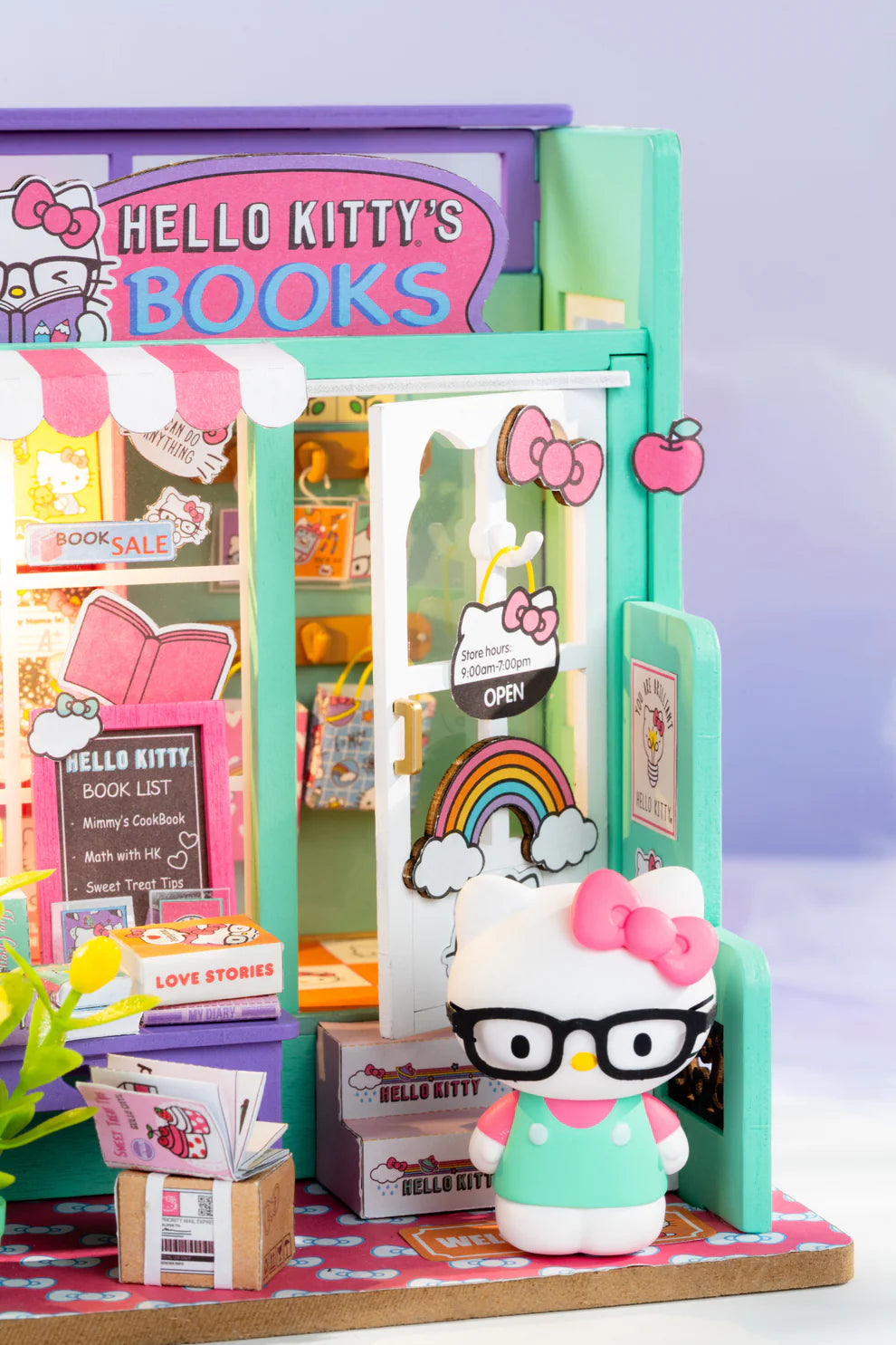Step into the charming world of Hello Kitty with this delightful miniature house kit, where she runs her very own bookstore. Filled with tiny books, adorable gifts, and colorful gift bags, this kit is decorated in Hello Kitty's iconic style. The charming "open" sign welcomes you into the cozy shop, where a little lamp lights up the interior, creating a warm and inviting atmosphere. Perfect for fans and crafters alike, this kit offers hours of fun and a beautiful keepsake to treasure.