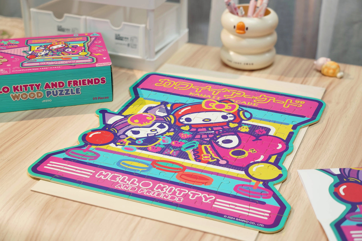 Discover joy with the Hello Kitty Wooden Jigsaw Puzzle: Kawaii Arcade (99pcs). This officially licensed Sanrio product features iconic Hello Kitty in 96 vibrant wooden pieces. Crafted for durability and a seamless fit, it's a delightful challenge for fans of all ages 8+. Embrace positivity and bring Hello Kitty to life with this charming puzzle – perfect for relaxation and family fun. Display your completed masterpiece proudly and celebrate the timeless appeal of Hello Kitty.