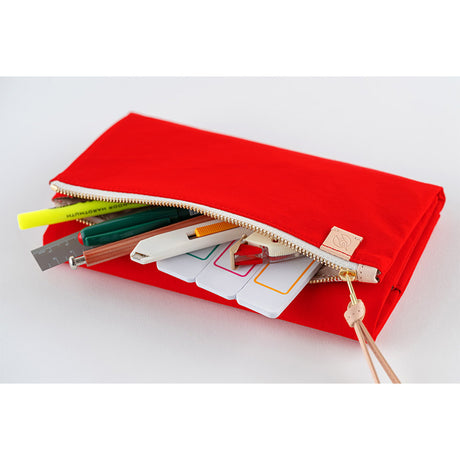 Its standout feature is the generously sized pocket, but its overall appearance remains clean and minimal. The vibrant and gorgeous red brightens your mood just by having it by your side. Though it folds into thirds and fastens with a magnetic closure, the cover is light in hand. The aim was effortless elegance, something that looks sharp without being flashy. The material is a soft nylon with a sophisticated sheen.