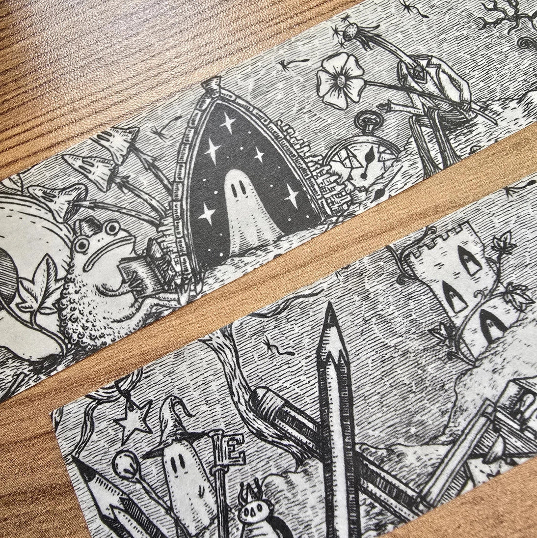 A unique and infinitely repeating fantasy landscape of melancholy oddities and curious characters, from original hand-drawn ink artwork by Jon Turner, recreated with incredible detail at miniature size in this washi tape that invites you to find new tiny details with every viewing.

This is a special extra-wide washi tape, 30mm high which really brings out all the tiny details. perfect for creating a decorative border when journalling, or for packing parcels with surreal style. 10m long.