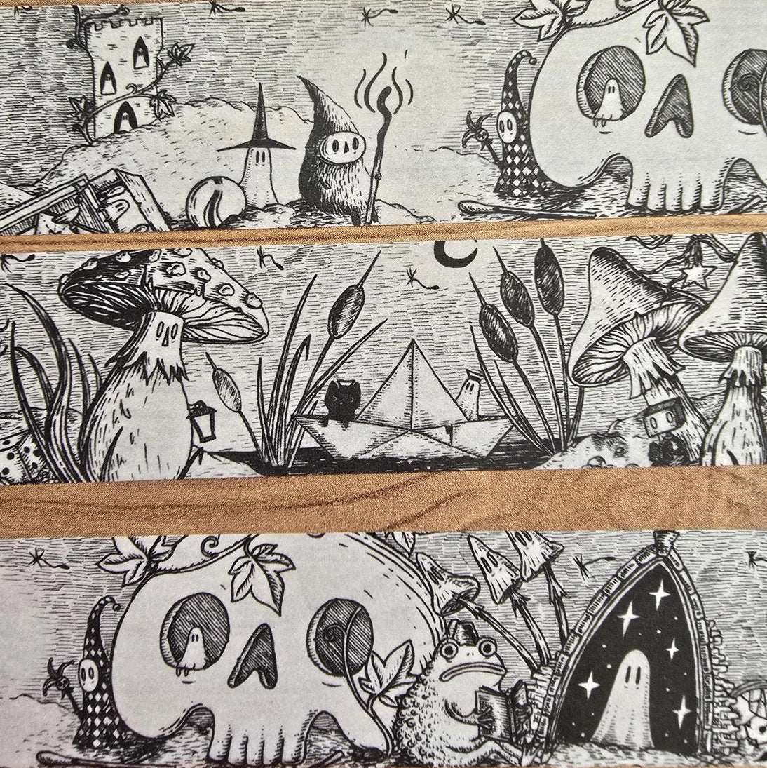 A unique and infinitely repeating fantasy landscape of melancholy oddities and curious characters, from original hand-drawn ink artwork by Jon Turner, recreated with incredible detail at miniature size in this washi tape that invites you to find new tiny details with every viewing.

This is a special extra-wide washi tape, 30mm high which really brings out all the tiny details. perfect for creating a decorative border when journalling, or for packing parcels with surreal style. 10m long.