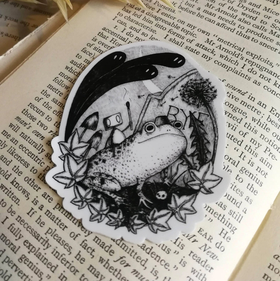 Sticker featuring a little robot and his faithful frog companion making their way through the haunted graveyard, from original pen and ink artwork by Jon Turner.