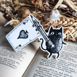 A little sticker based on my friend Simon the black cat, flying his Ace flag, from my original pen and ink artwork.