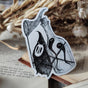 Die-cut vinyl sticker featuring a little bottle-backed ghost hunter, taken from Jon Turner's book Fragments.