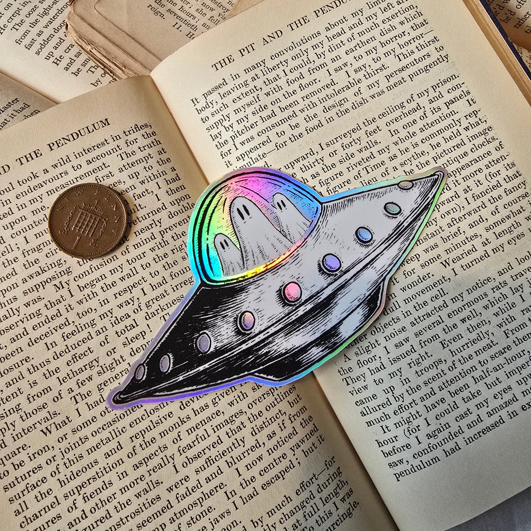 A spooky little UFO on a lovely die-cut holographic vinyl sticker from original pen and ink artwork by Jon Turner.