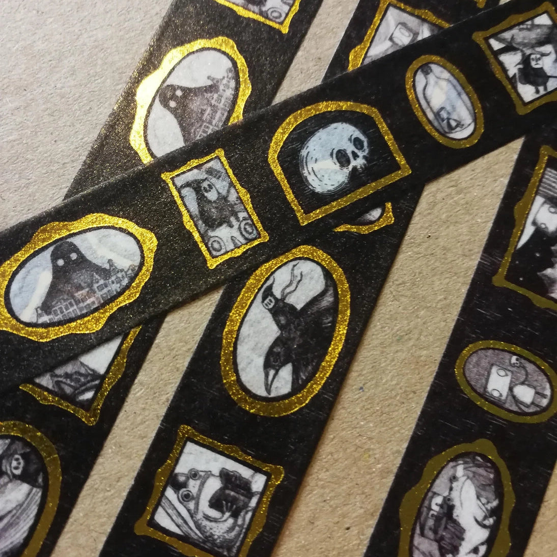 Turn every surface into a tiny gallery with this washi tape featuring tiny Jon Turner artworks in shiny gold frames, an array of little robots, ghosts and other spooky oddities. Perfect for spooky journalling or curious correspondence.

Two designs available, with each tape featuring 16 miniature masterpieces in a repeating pattern. Each roll measures approximately 15mm wide, and the roll is 10m long; they are cello wrapped and decorated with branded stickers on either side.



15mm wide
10m length