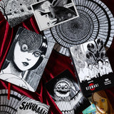 Spiral into horror with this deluxe, officially licensed set of 100 collectible postcards from legendary manga author Junji Ito. Each high-quality print showcases iconic artwork from Uzumaki, his bestselling manga series about a town cursed by spirals.

A four-time Eisner Award winner and New York Times bestselling author, Junji Ito has inspired generations of readers and creators with his legendary works of cosmic horror.