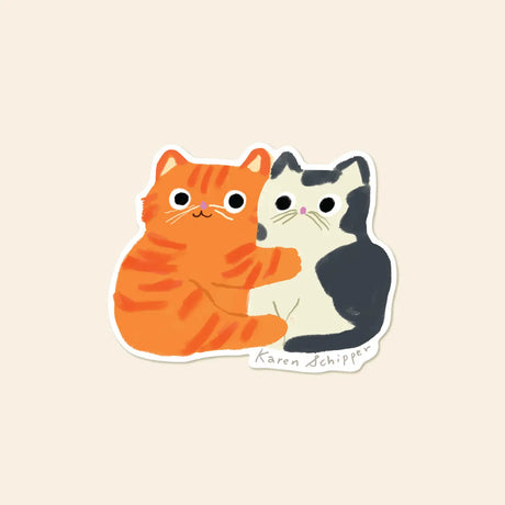Karen Schipper Vinyl Sticker - Cat Hug

Some stickers say it all without a single word. Cat Hug Sticker features two cuddling cats — an orange tabby wrapping an arm around a black-and-white friend — making it a cute cat sticker that instantly feels warm and giftable.&nbsp;

Made from matte-coated, waterproof vinyl, it’s durable enough for laptops, planners, water bottles, and more. It’s an easy impulse add-on for cat people, best friends, and shoppers looking for a small but meaningful gift.

Measures appro