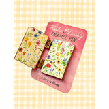 A tiny treasure for book lovers, wildflower wanderers, and collectors of small beautiful things.
This interactive enamel pin features a working hinge that allows the miniature book to open and close, revealing a hidden floral spread inside. Inspired by beloved vintage books and meadow blooms, it’s a little story you can wear on your jacket, tote, sweater, or favorite old flannel.

Details:
• 1.75” on the longest side
• Interactive hinged design that opens like a tiny book
• Gold-plated finish
• Rich, detail