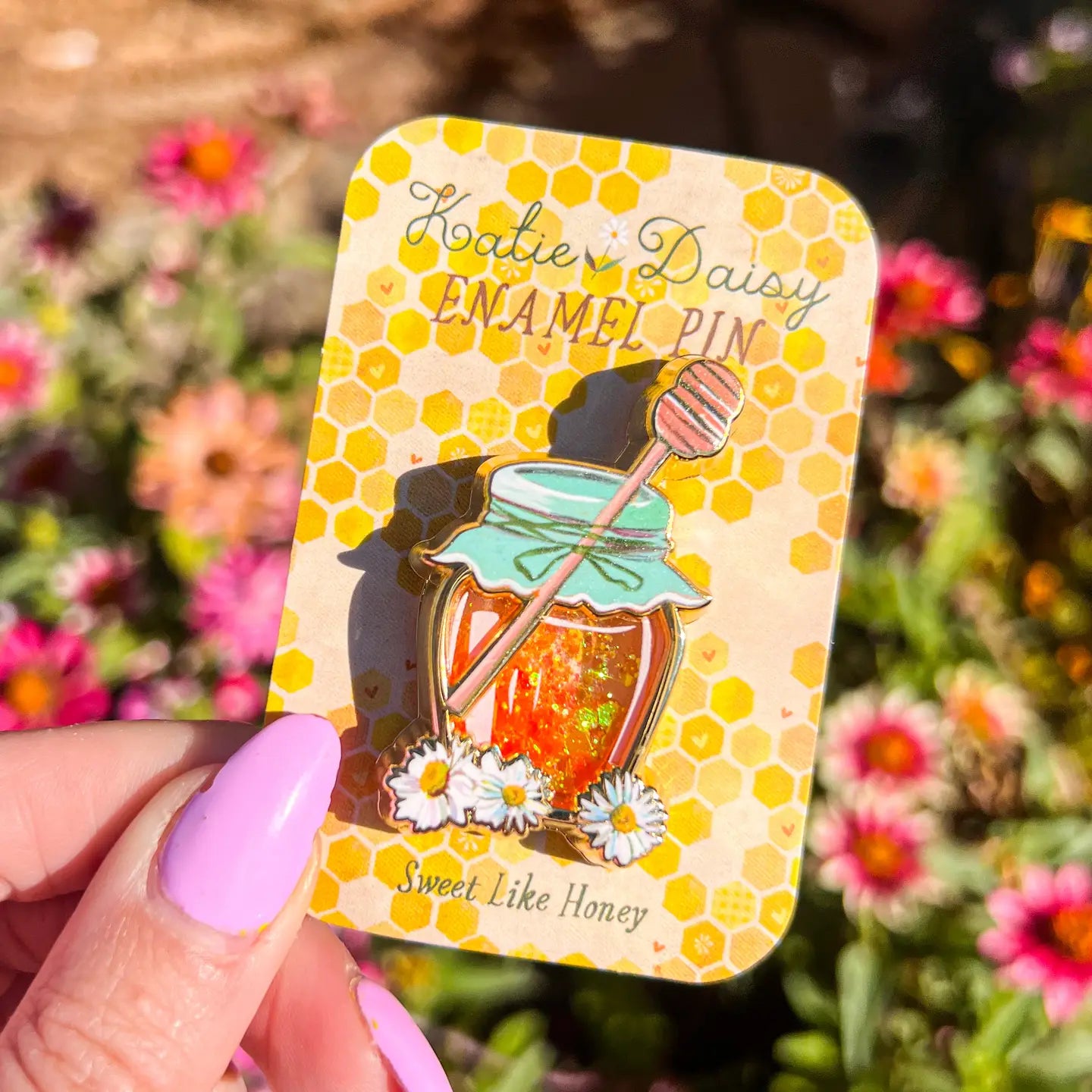 A tiny treasure to pin on your jacket, tote, or favorite old flannel—each one a little love letter to country delights, small joys, and the art of noticing.

Details:

Liquid glitter that catches the light like real honey&nbsp;
Gold-plated finish&nbsp;
Single post so it stays put&nbsp;
Packaged on a sweet little honeycomb card


Designed with love in my Oregon studio. Manufactured in China.
Collect them all or gift one to a kindred spirit. 🌸
