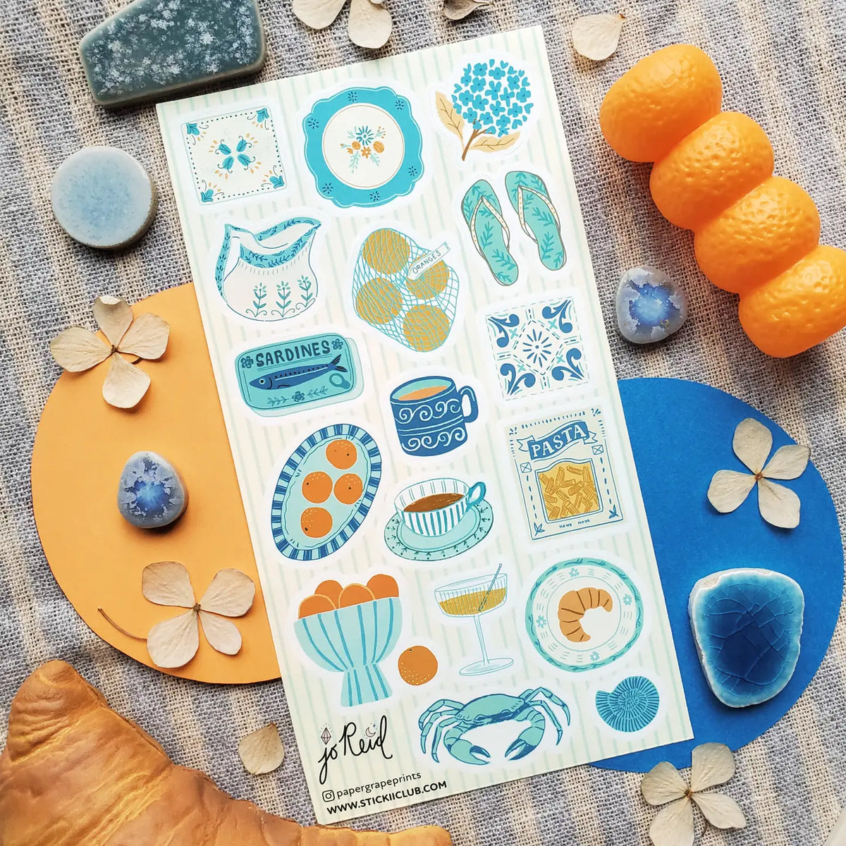 🩴🍊 @papergrapeprints is serving up a sun-soaked spread of seaside favorites, and we’ll take one of everything! Bright oranges, sardines, pasta, pretty ceramics, hydrangeas, and that perfect blue crab come together in a dreamy mix of coastal color and vacation-day charm. Add flip-flops, something cold to sip, and absolutely zero plans. Art by: @papergrapeprints

Top Coating: None
Adhesive Layer: Paper
Backing Layer: Clear PET
6.69" x 3.54".
Weight - 0.03lbs
1 sheet included