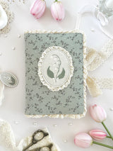 lily&nbsp;of the valley fabric notebook cover. sewn together with careful craftsmanship. lined with lace ruffles for that extra romantic, cottage-core, fairytale touch. meant to protect your notebooks &amp; a keepsake for your beloved stationery :)

♡ floral linen pattern with ruffle lace edging &amp; lily of the valley embroidery

♡ lace ribbon enclosure to help keep your notebooks closed

♡ 7 pockets total (left sleeve: 5 pockets | right sleeve: 2 pockets)

♡ x1 lace ribbon book mark with gold bow pendant