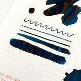 Treat is a playful blue-grey that proves the sweetest rewards are often unexpected. A cool stormy slate base is illuminated by bright cerulean highlights and warm rosy undertones that appear where the ink pools and shades.