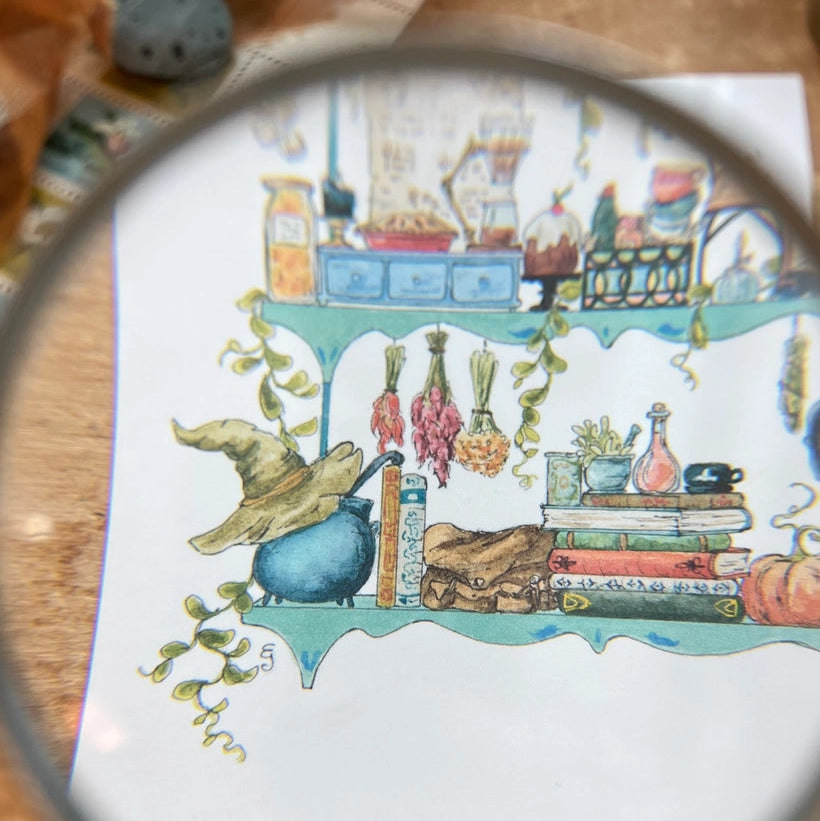 Postcard featuring my original watercolor and ink illustration of the oddities, books, tools, and trinkets tucked away in the shelves of a kitchen witch, including a sweet cat and a stained glass lamp.