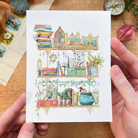 Postcard featuring my original watercolor and ink illustration of the oddities, books, tools, and trinkets tucked away in the shelves of a sea witch, including a sea otter relaxing in a cauldron with a good book.

• Printed on high quality card stock
• Each postcard measures 4.25 x 5.5" (A2)