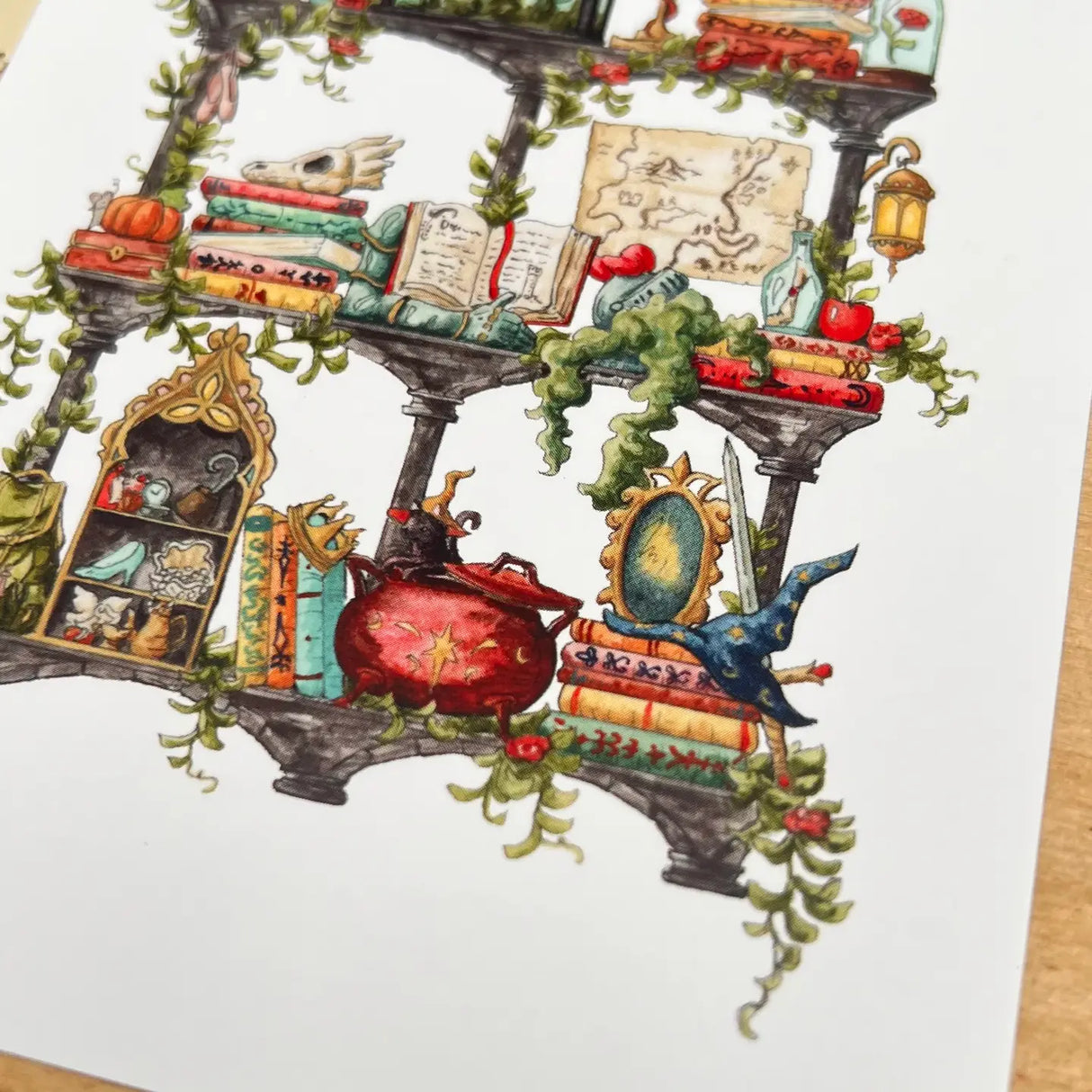 Postcard featuring my original watercolor and ink illustration of the various enchanted items collected by a storybook witch as she travels throughout all your favorite fairytales, including a charming castle, a glass-encased rose, and a brightly colored dragon, all nestled on stone shelves that evoke mysterious castle corridors covered in rose vines.