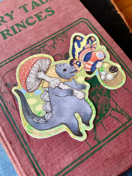 Two little Kaiju friends go foraging for mushrooms together. This vinyl matte sticker is weather and waterproof-stick it on a notebook, bike, or car- it's going to stick around! Heck, throw it on a water bottle and through the dishwasher. This sticker can go anywhere.

Sticker measures 3.9" x 4"

Printed in USA.
