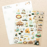This cute sticker designed by illustrator Mariko Fukuoka looks like a delicious aroma might waft through the air at any moment. Freshly baked cookies served with coffee brewed by a bear barista.


Printed on PET material, the stickers have a smooth, durable finish that’s easy to peel and place - great for both everyday use and special projects.

✨ Product Details

Smooth, durable PET sticker material
Perfect for planners, journals, scrapbooking, and cardmaking
Backing Sheet Size: 141 × 188 mm
Sticker sheet 