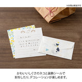 A refreshing stationery design featuring yellow and light blue flowers. On the writing side of the stationery, you can see a cat playing with butterflies in a flower garden.
Stickers adorned with cat gestures like holding flowers in its mouth or giving an upward glance are soothing